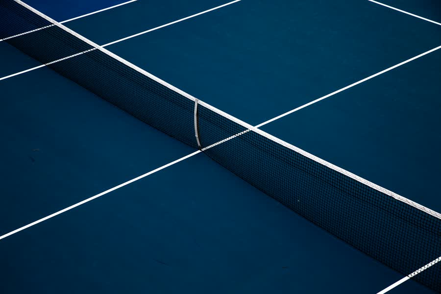 An empty tennis court at night
